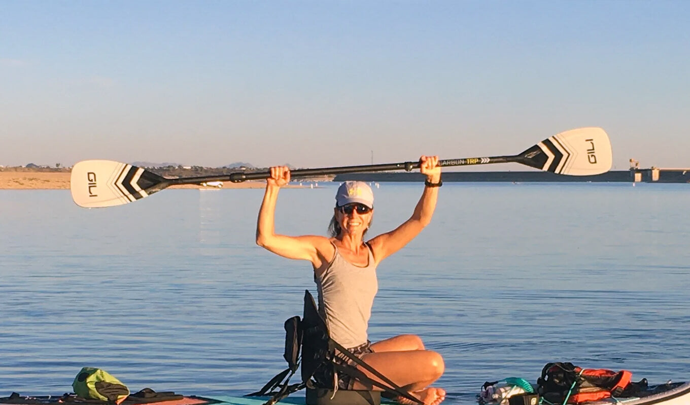 woman holding a GILI kayak paddle