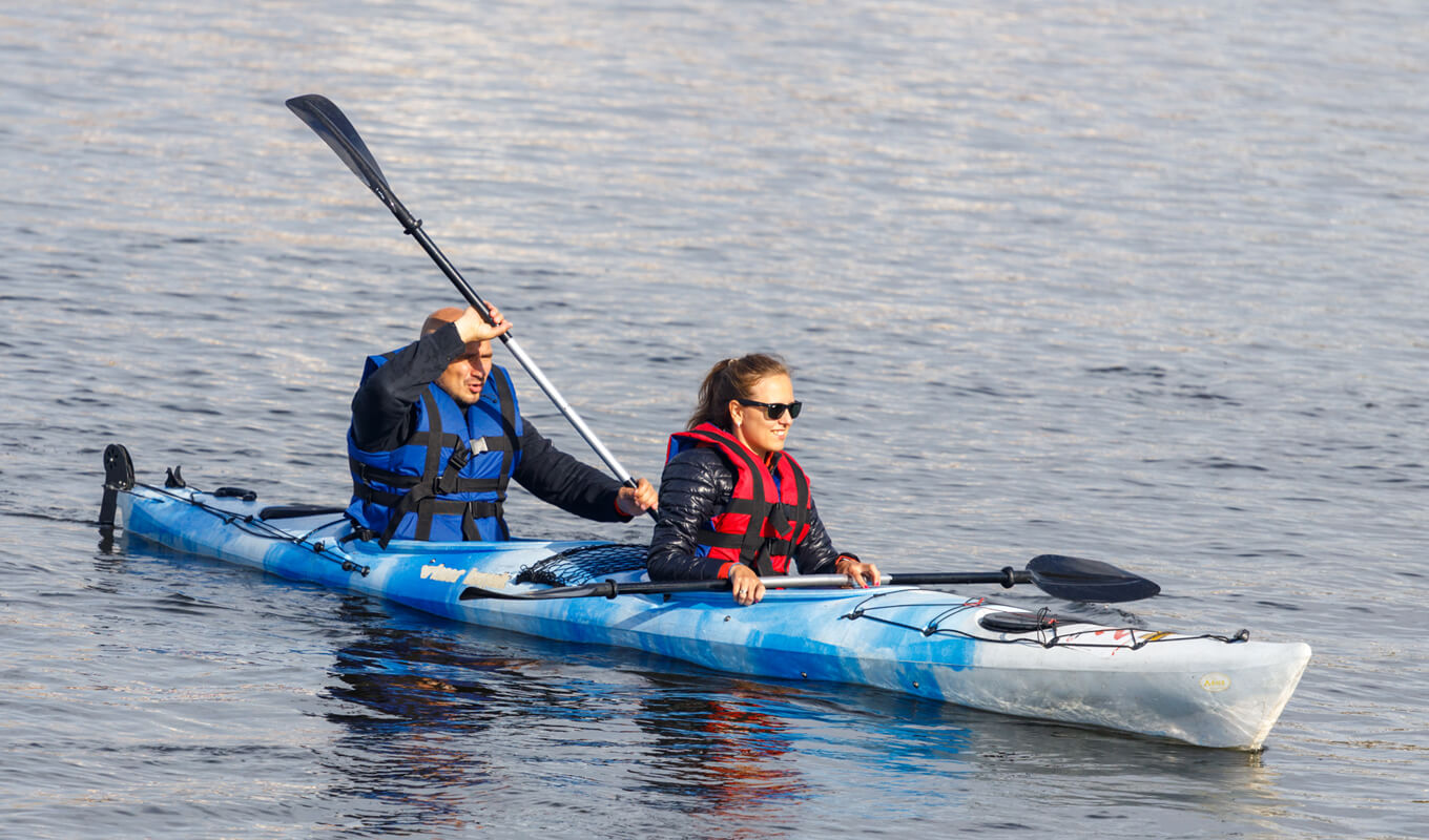 Man and a woman on a blue tandem kayak