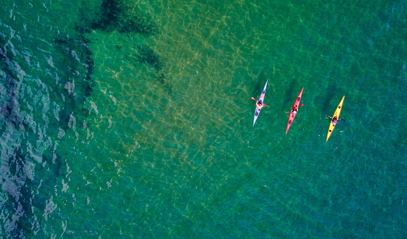 Red, yellow and blue kayak in the ocean