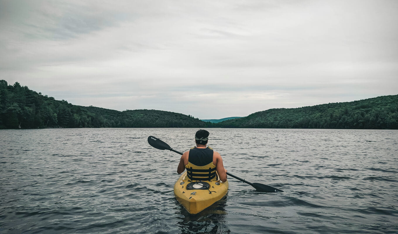 Man on a yellow sit on top kayak