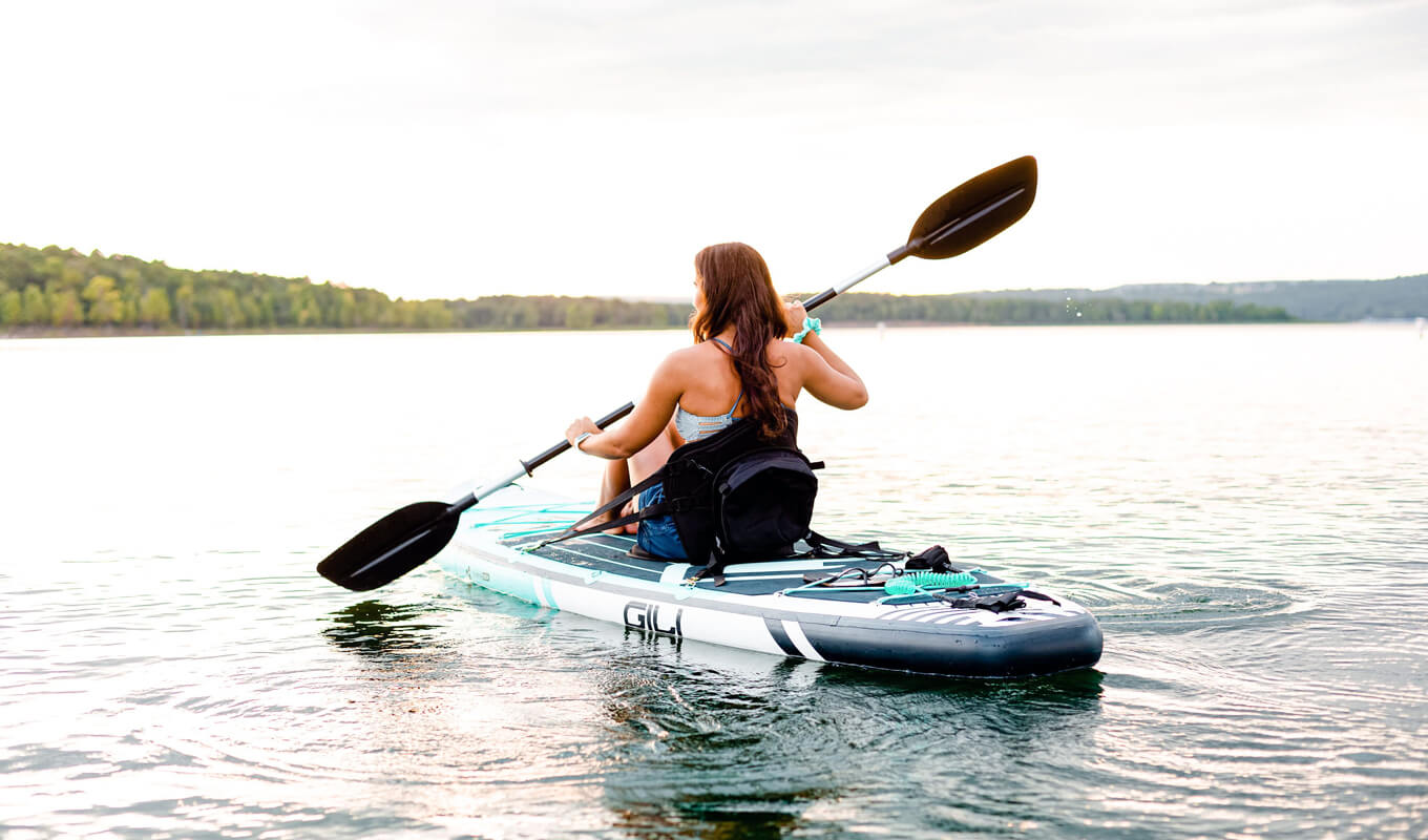 Woman paddling inflatable SUP