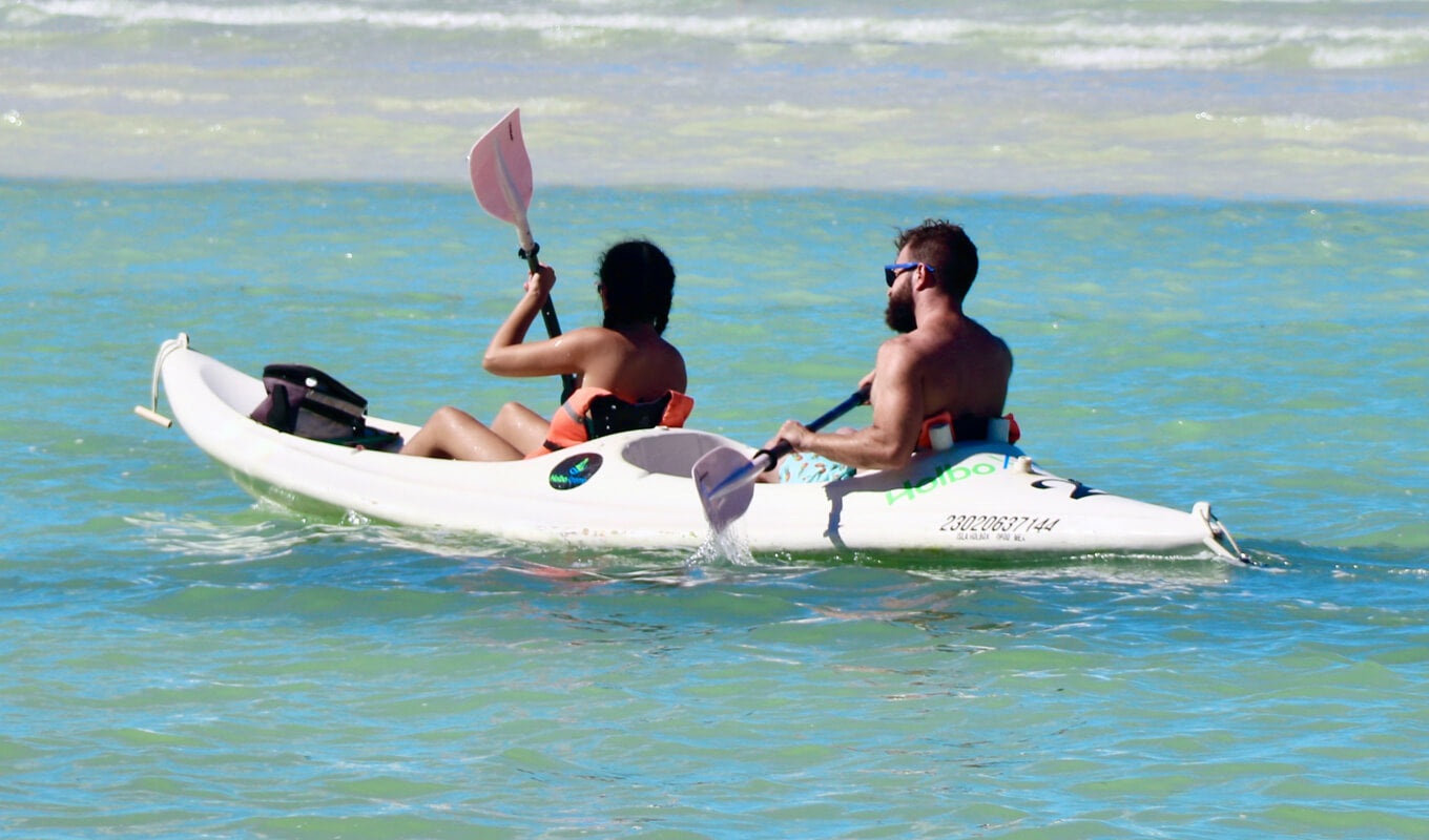 Man and a woman riding a sit on top tandem kayak